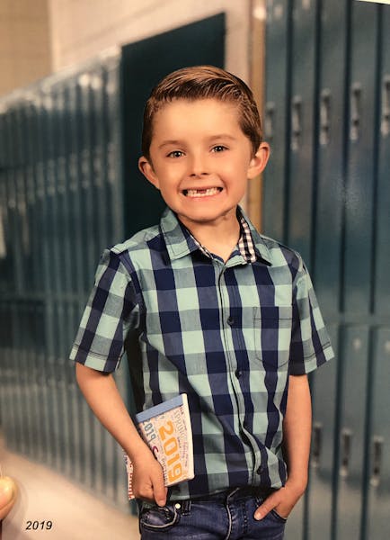 a young boy in a striped shirt