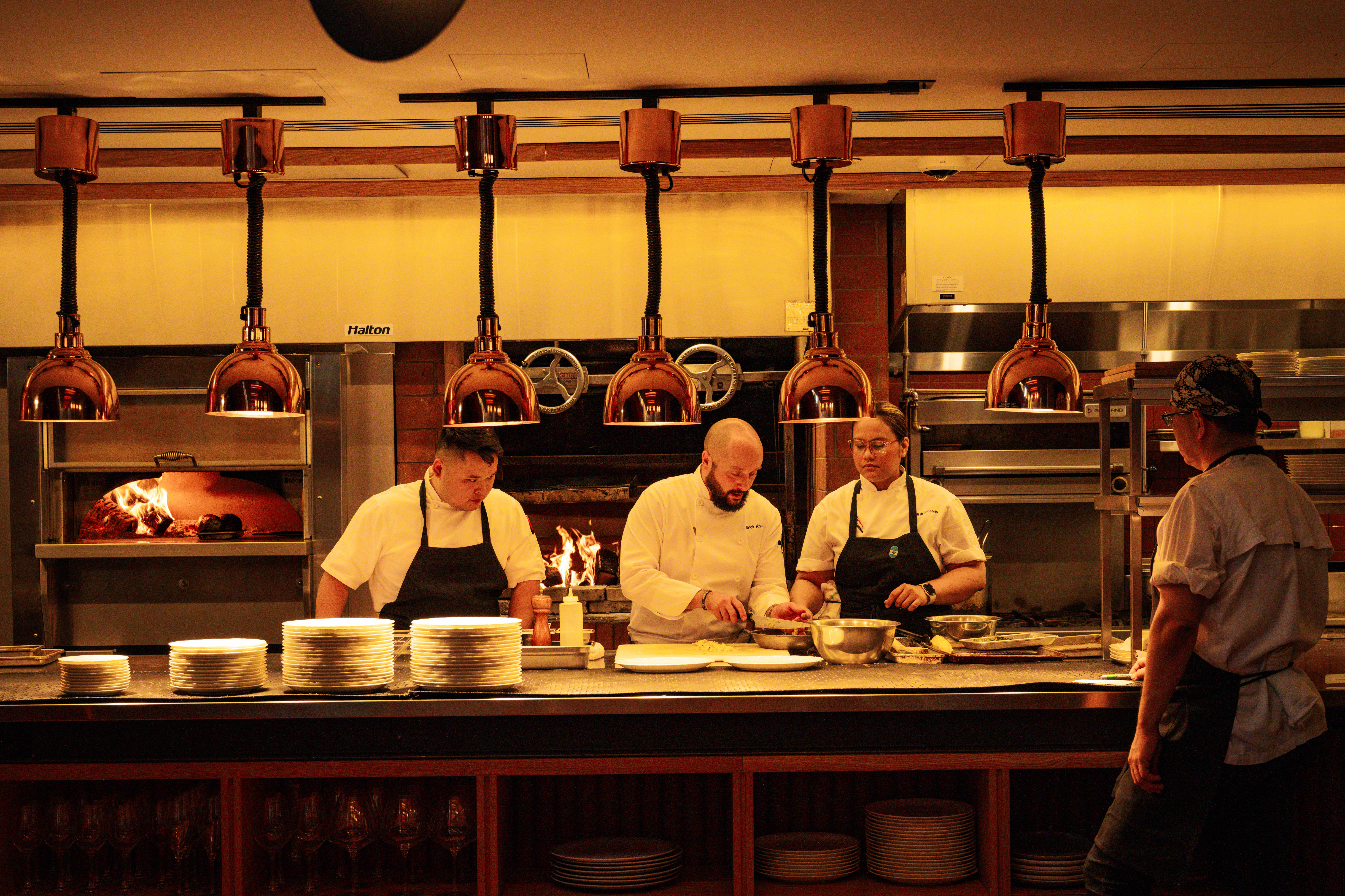 a group of people preparing food in a kitchen