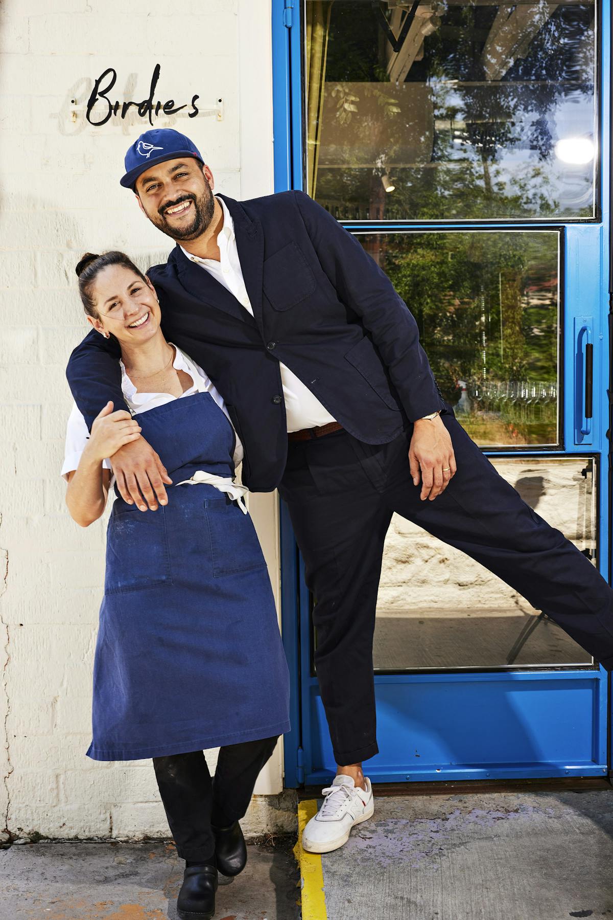 a man and a woman standing in front of a building