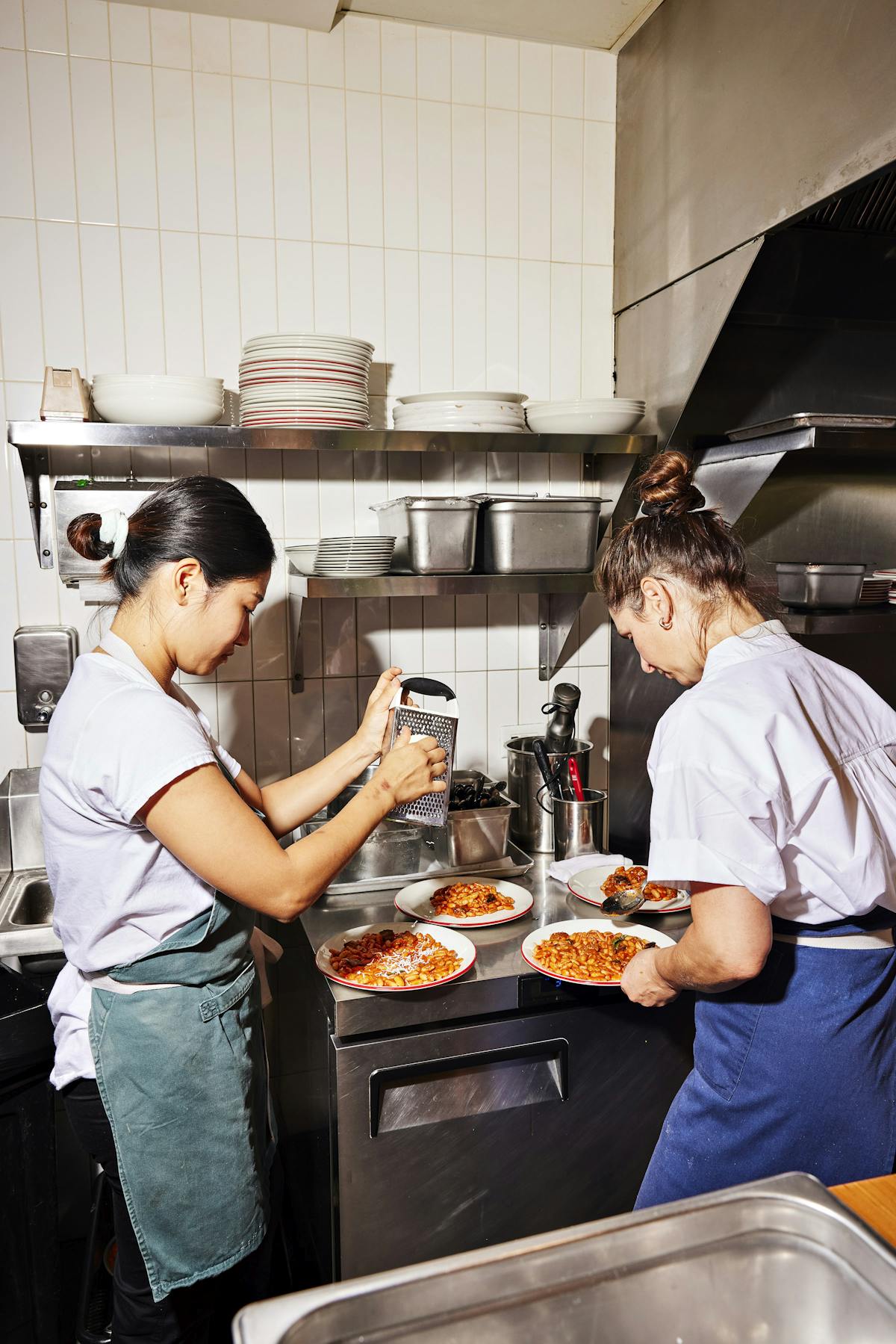 a woman cooking in a kitchen preparing food