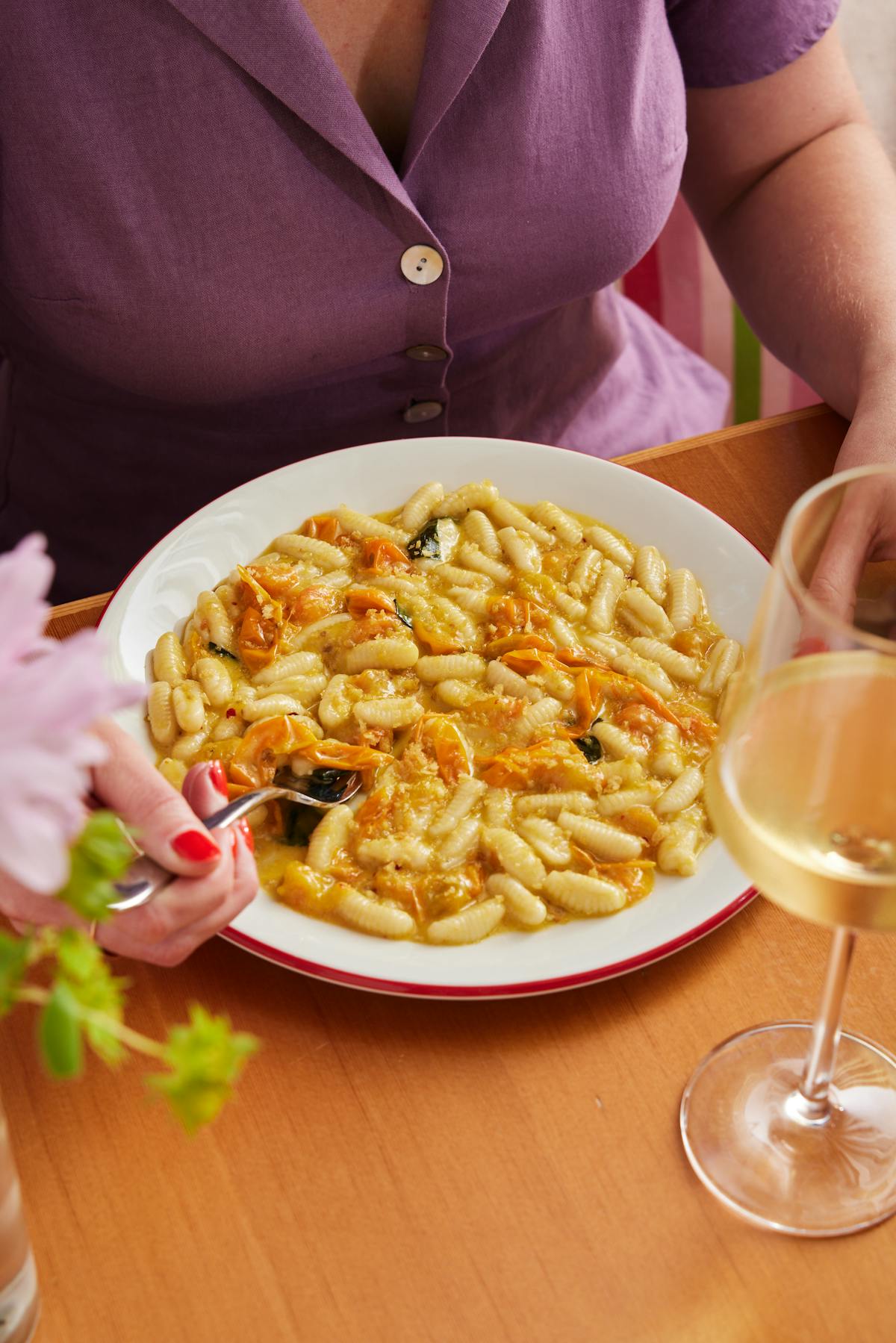 a woman sitting at a table with a plate of food
