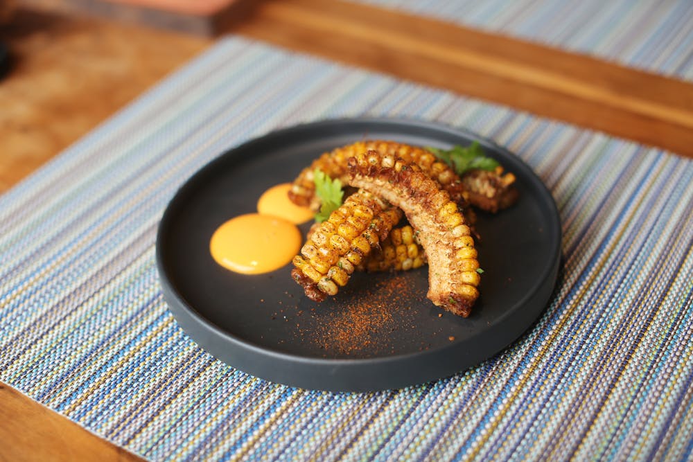 a plate of food sitting on top of a wooden table