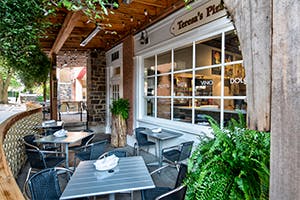 a group of people sitting at a table in front of a building