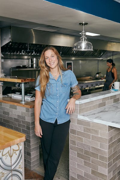 a woman standing in a kitchen
