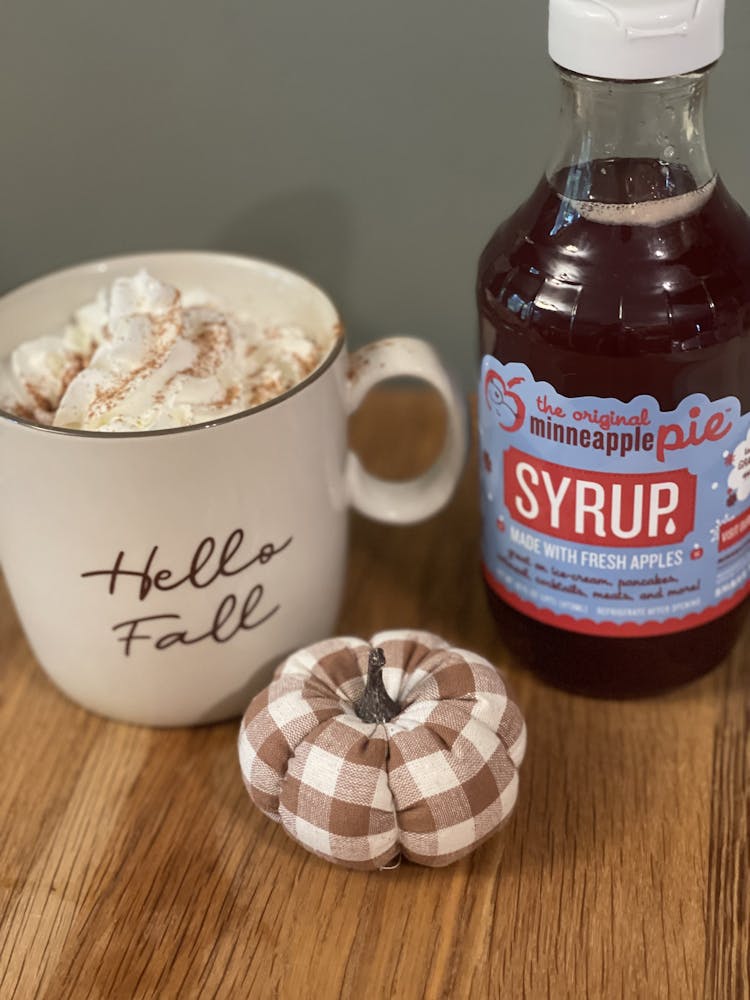 a bottle of beer next to a cup of coffee