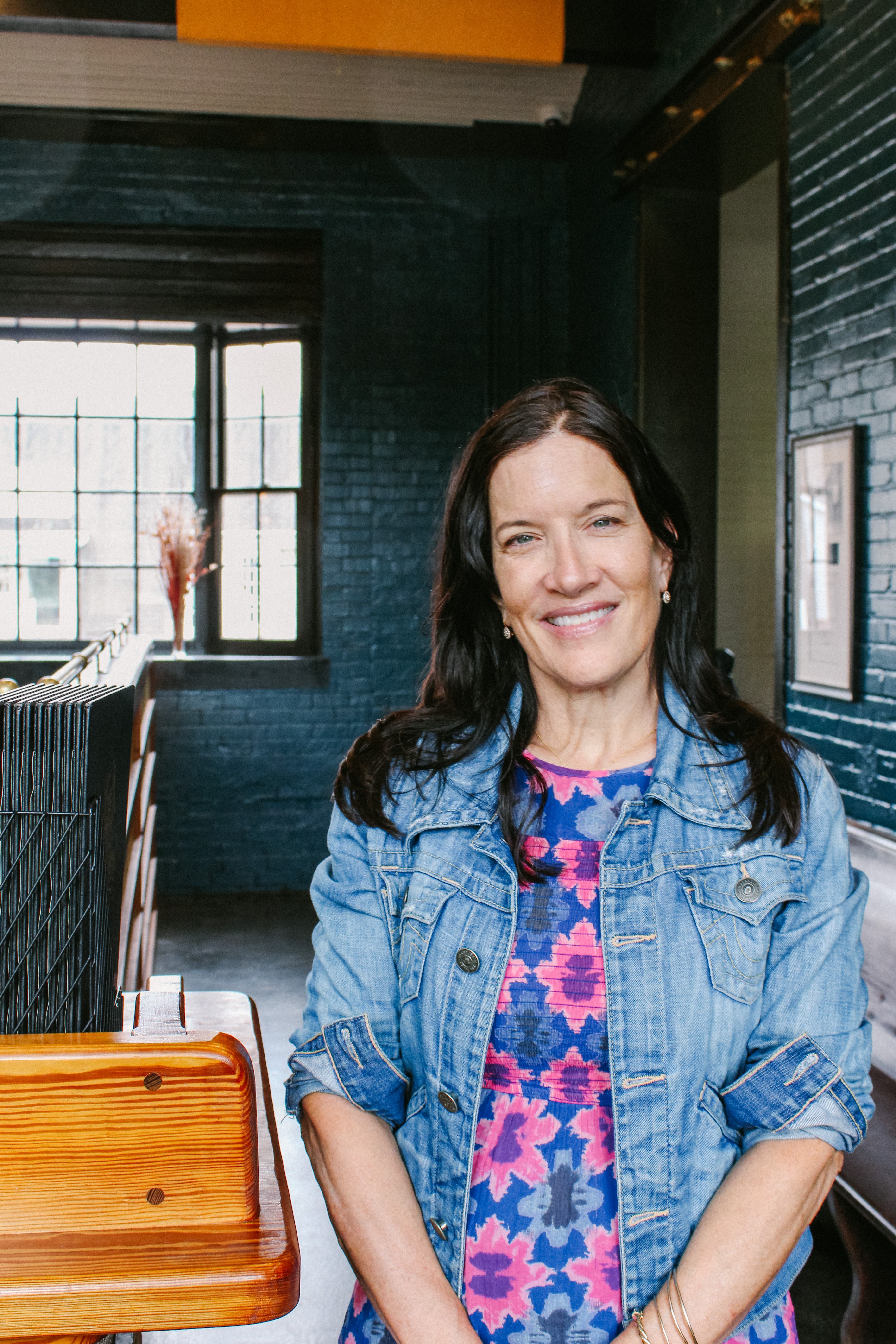 a woman standing in front of a window