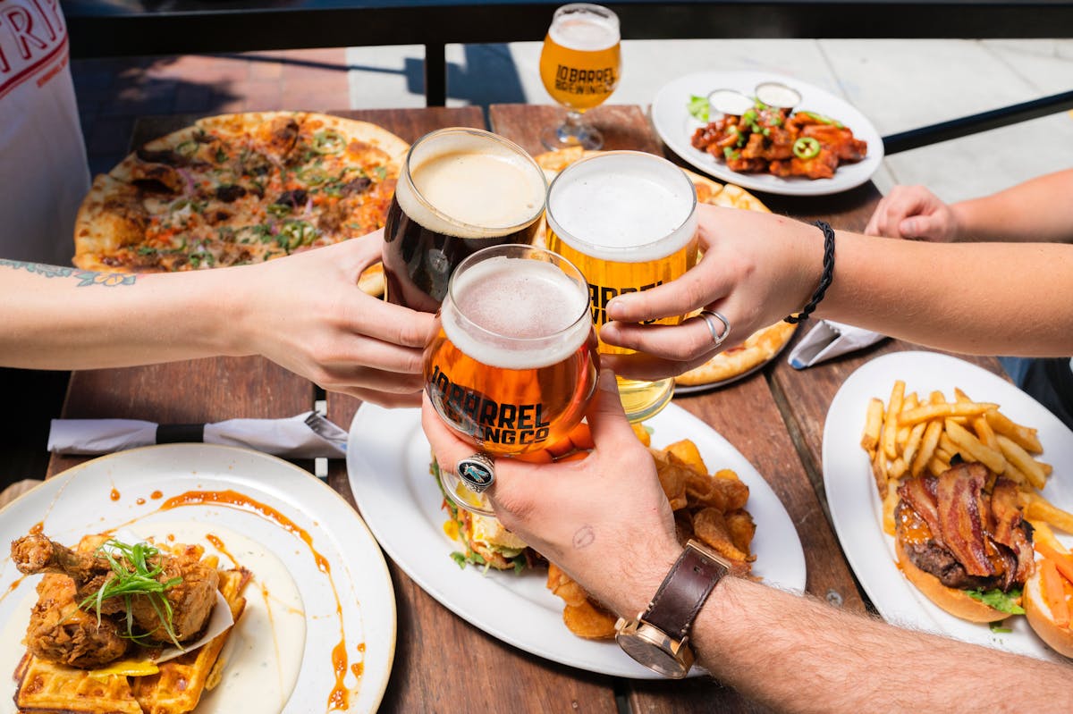 a group of people sitting at a table with a plate of food
