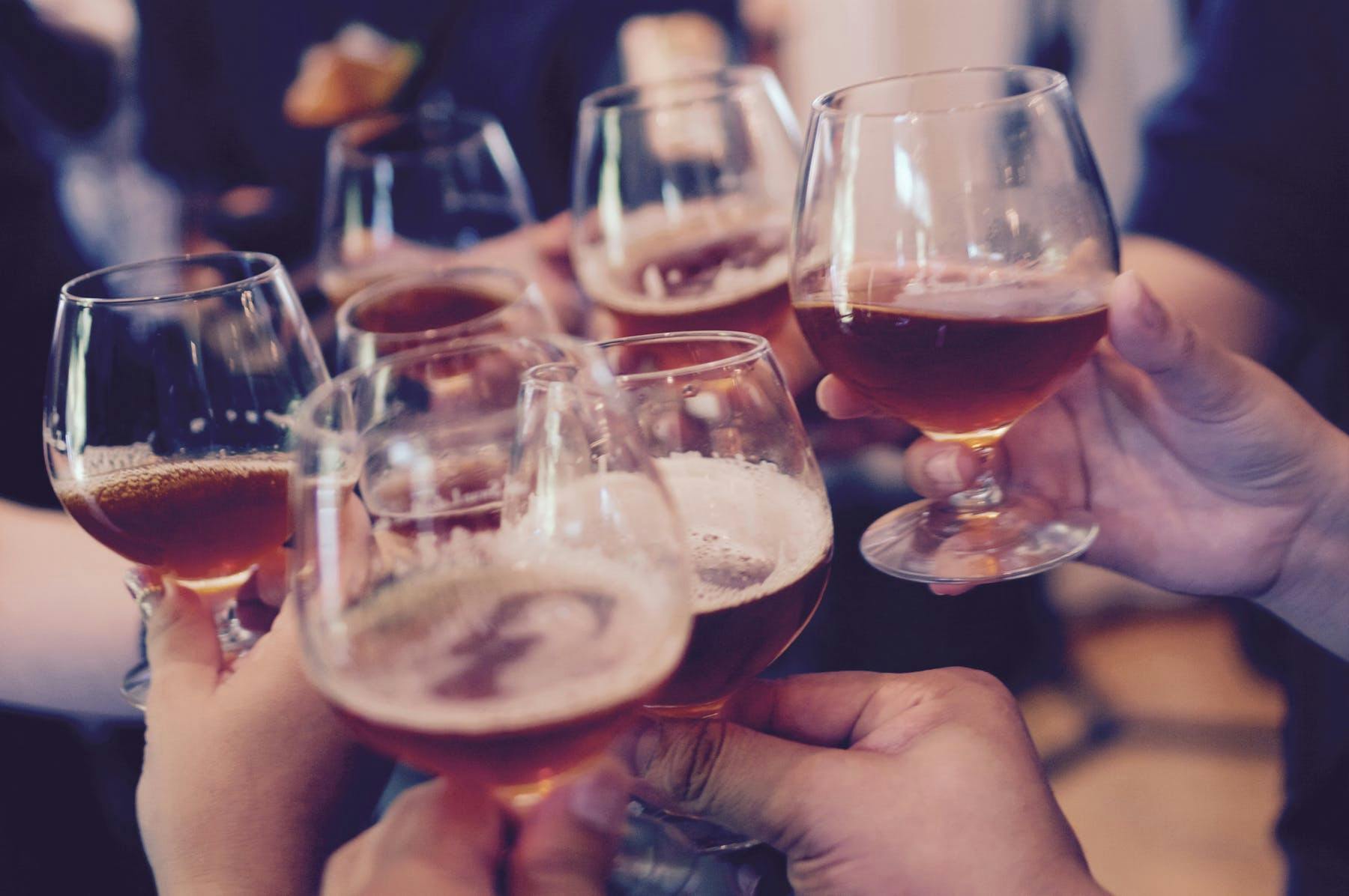 a hand holding a glass of wine