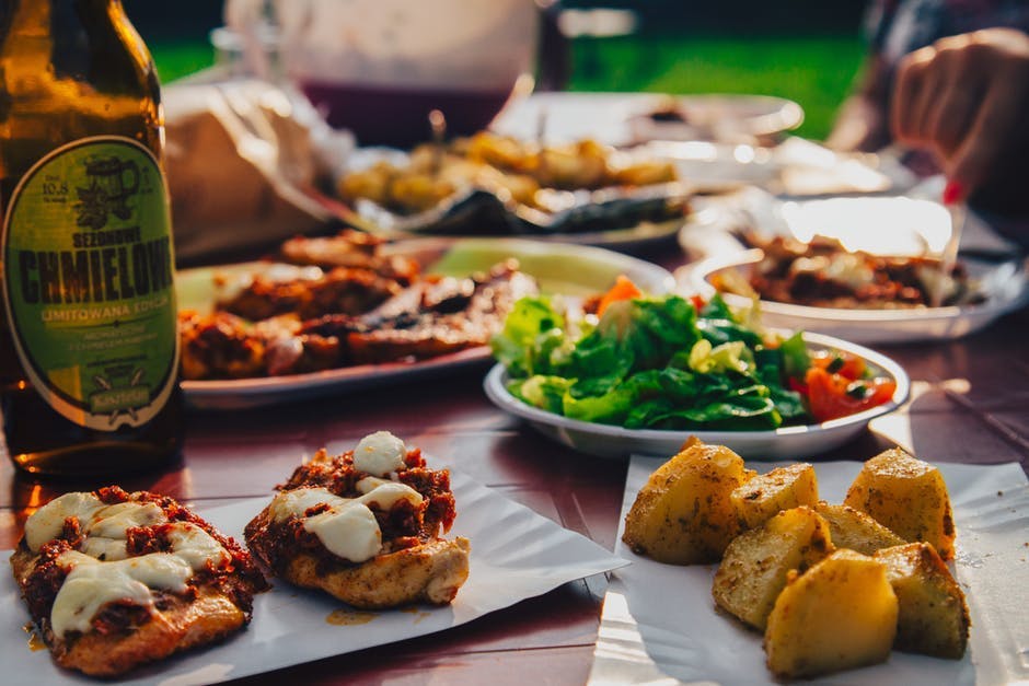 a group of people sitting at a table with a plate of food