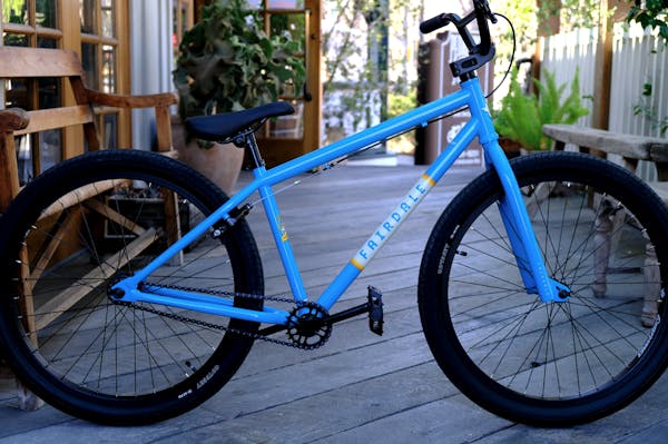 a bicycle parked on a sidewalk