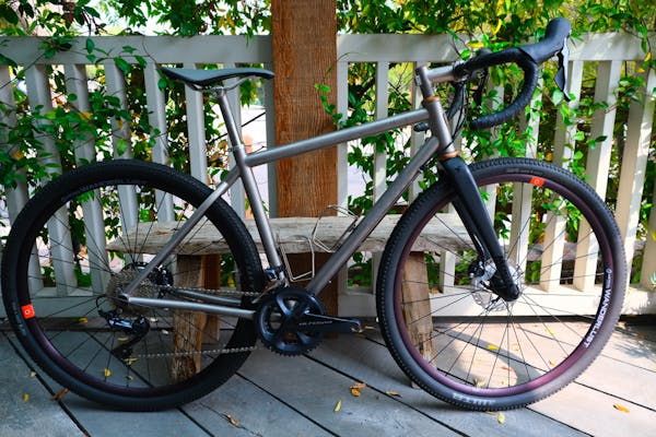 a bicycle parked on a sidewalk