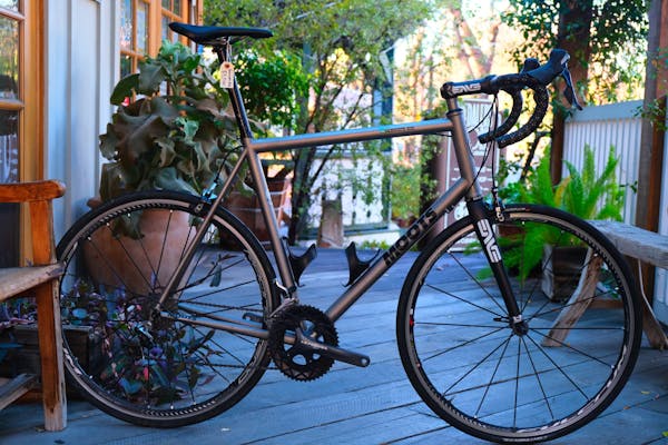 a bicycle parked on a sidewalk