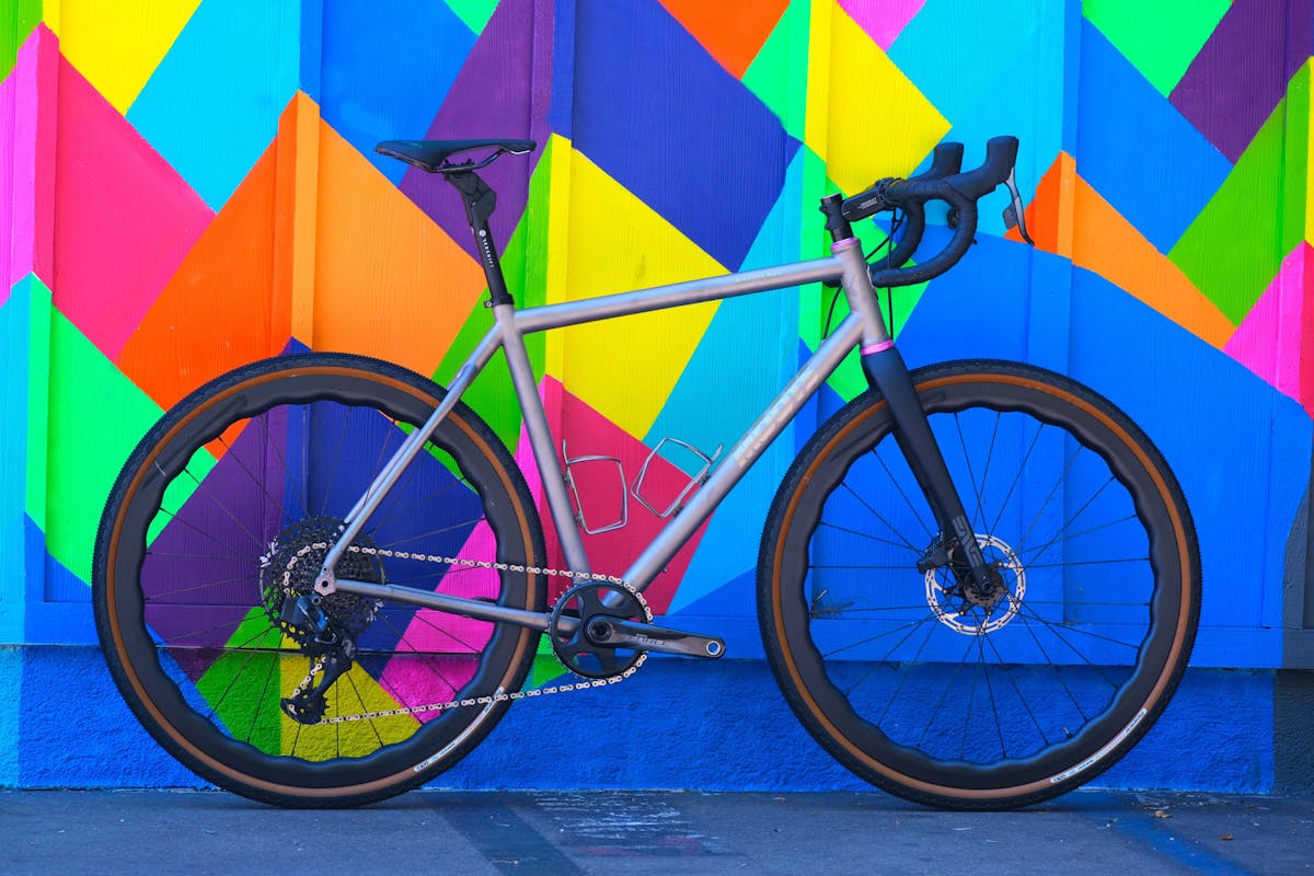 a bicycle parked in front of a colorful kite