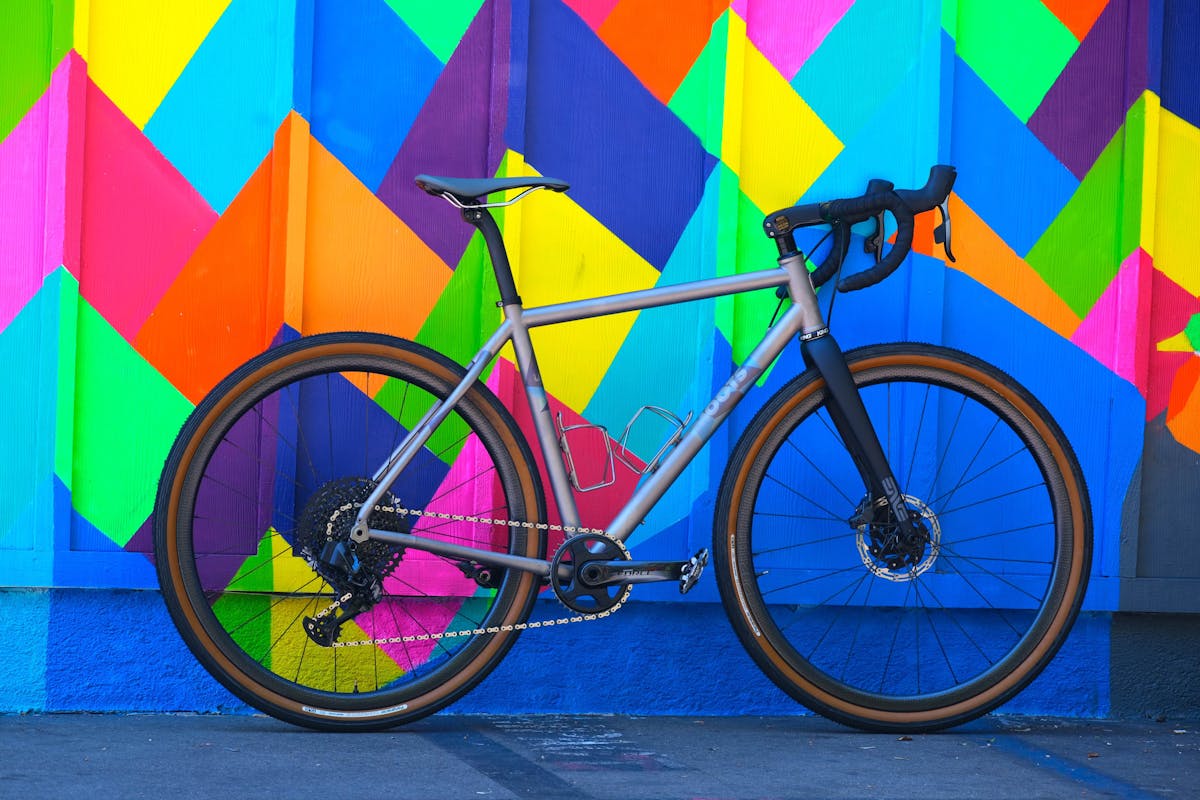 a bicycle parked in front of a colorful kite