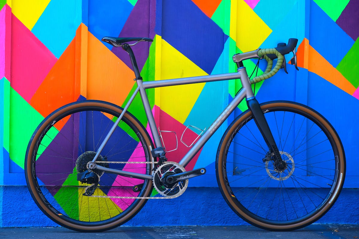 a bicycle parked in front of a colorful kite