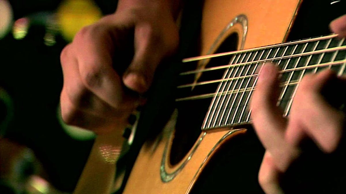 a close up of a person holding a guitar