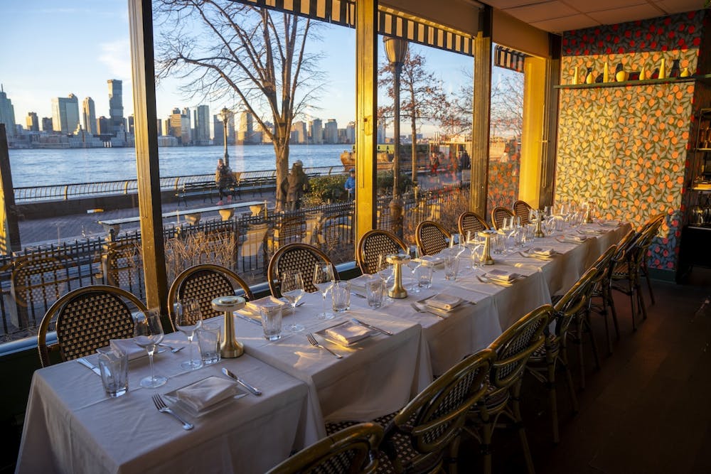 Beautiful al fresco dining area with white tablecloths and floral decor