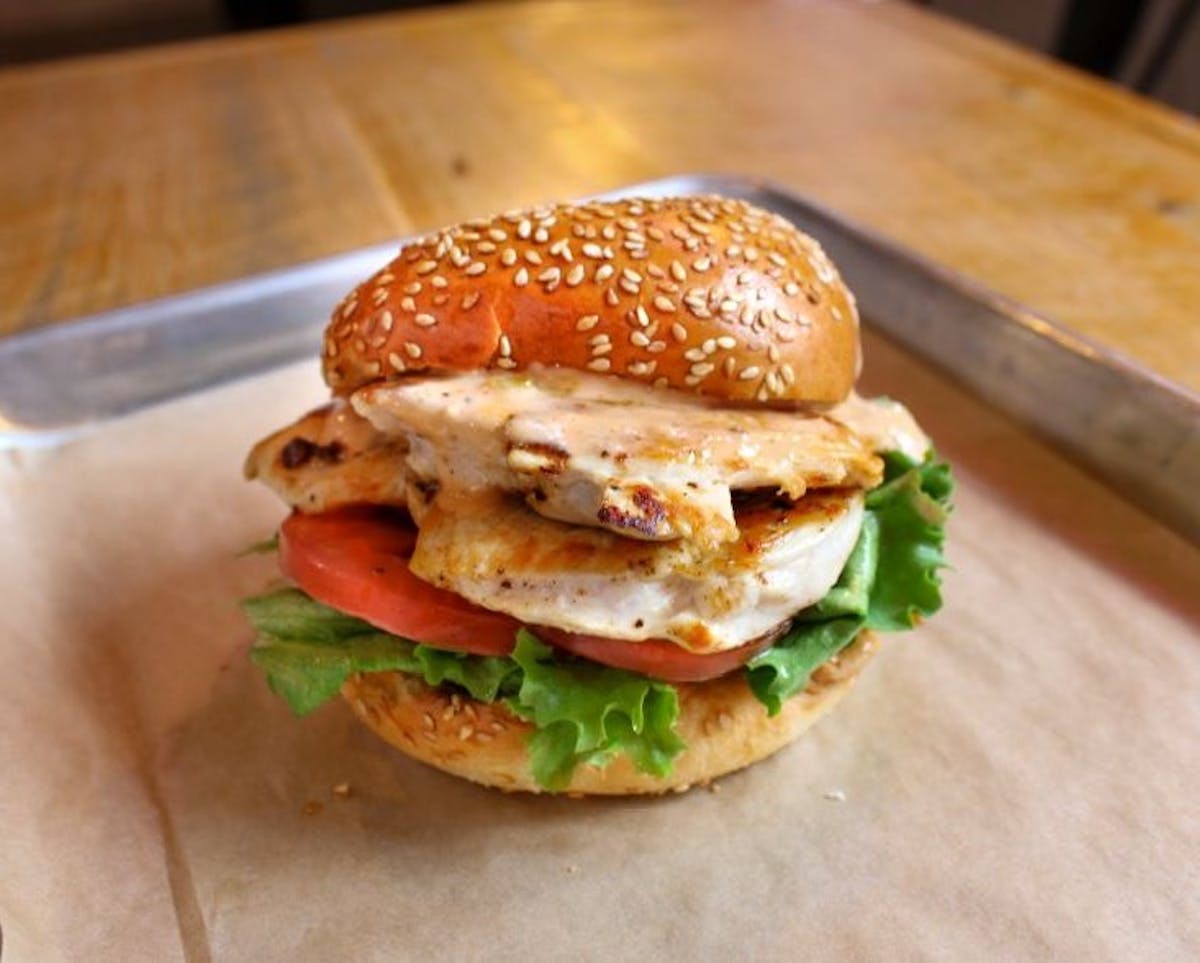 a close up of a sandwich sitting on top of a wooden table