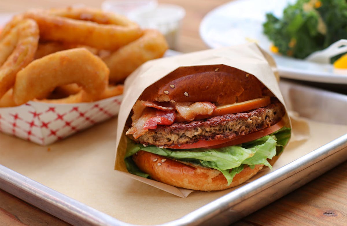 a close up of a sandwich sitting on top of a wooden table