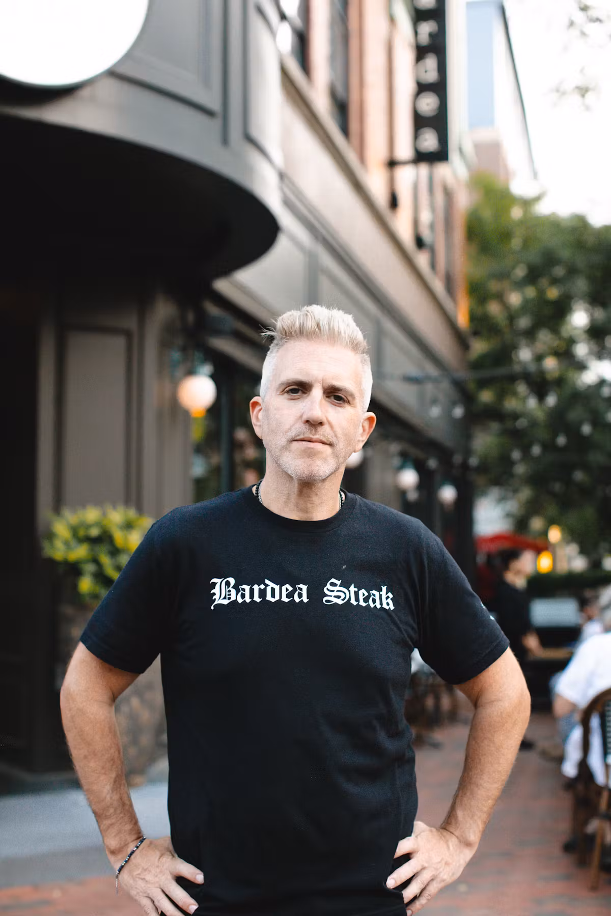 a man posing with a black t-shirt