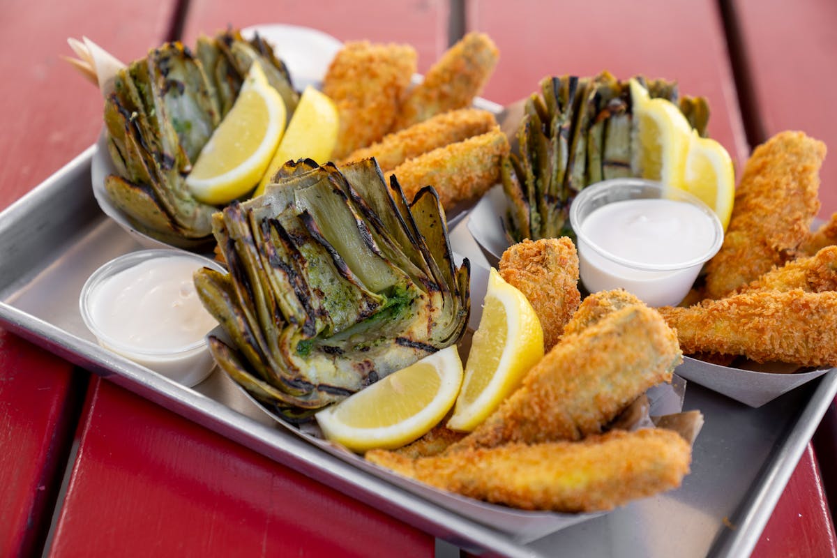tray of artichokes on picnic table
