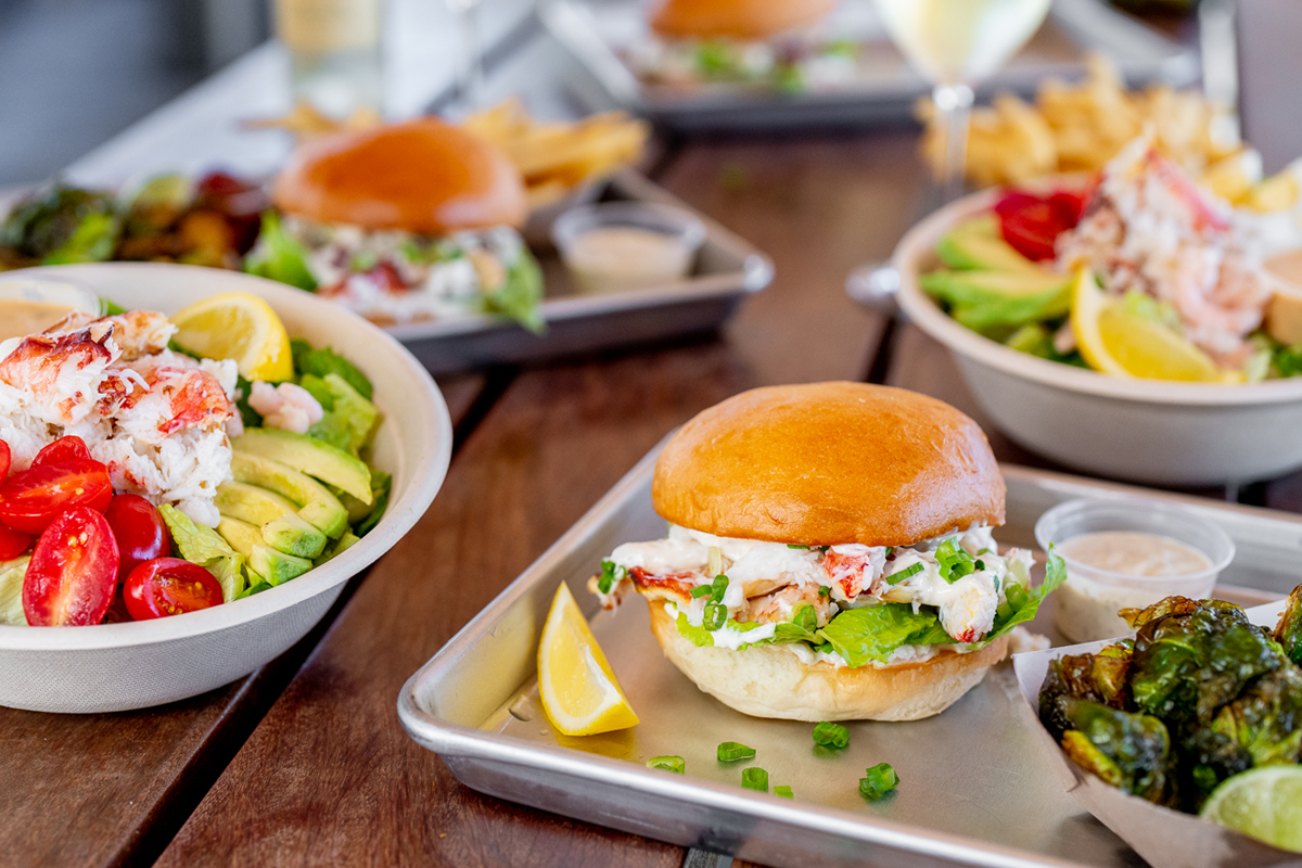 a plate of food with a sandwich and a bowl of salad