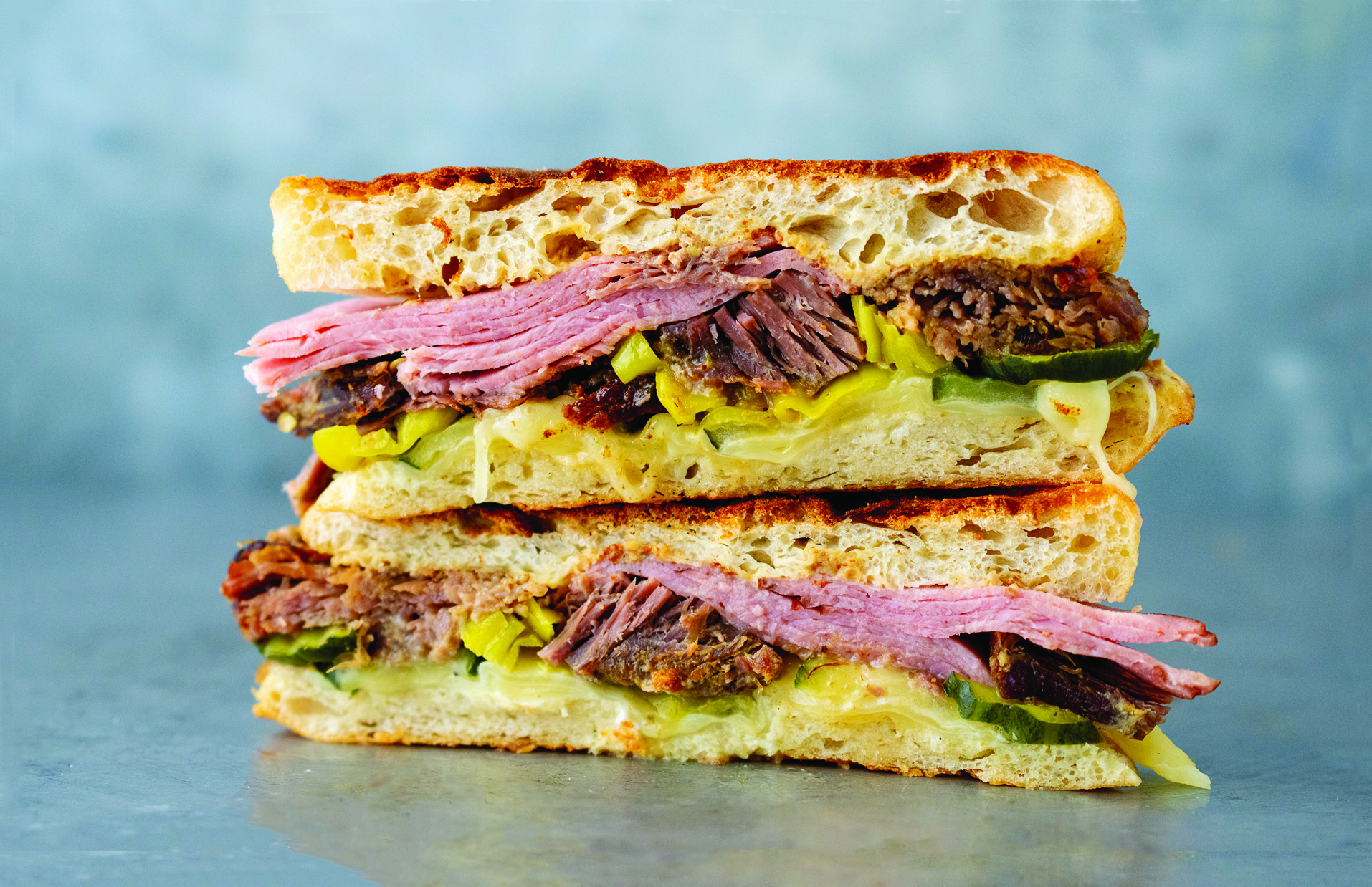 a stack of sandwiches with meat and cheese