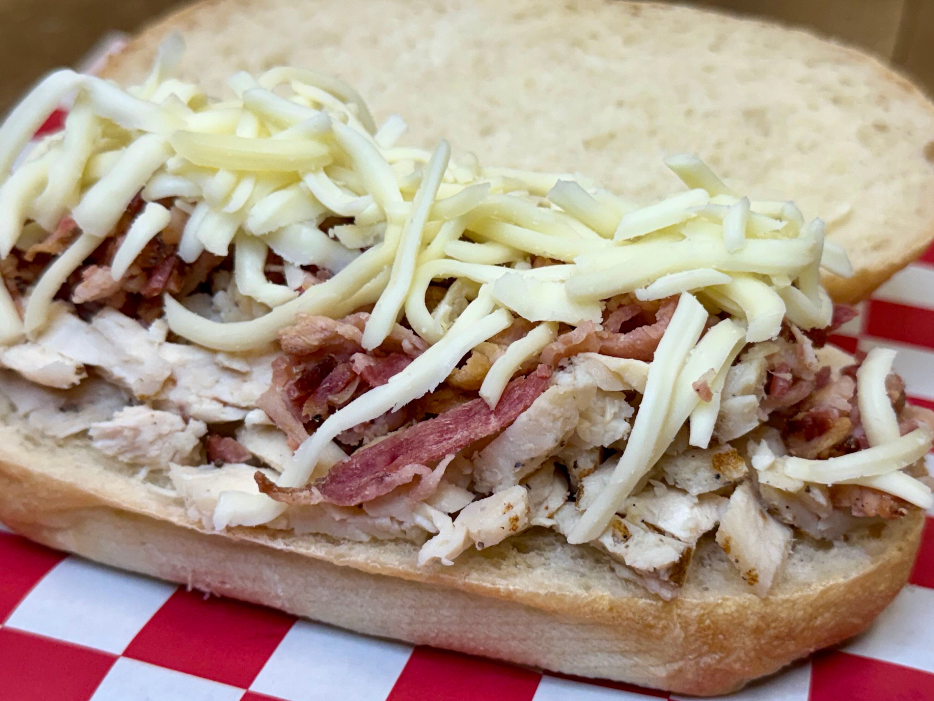 a sandwich with meat and cheese on top