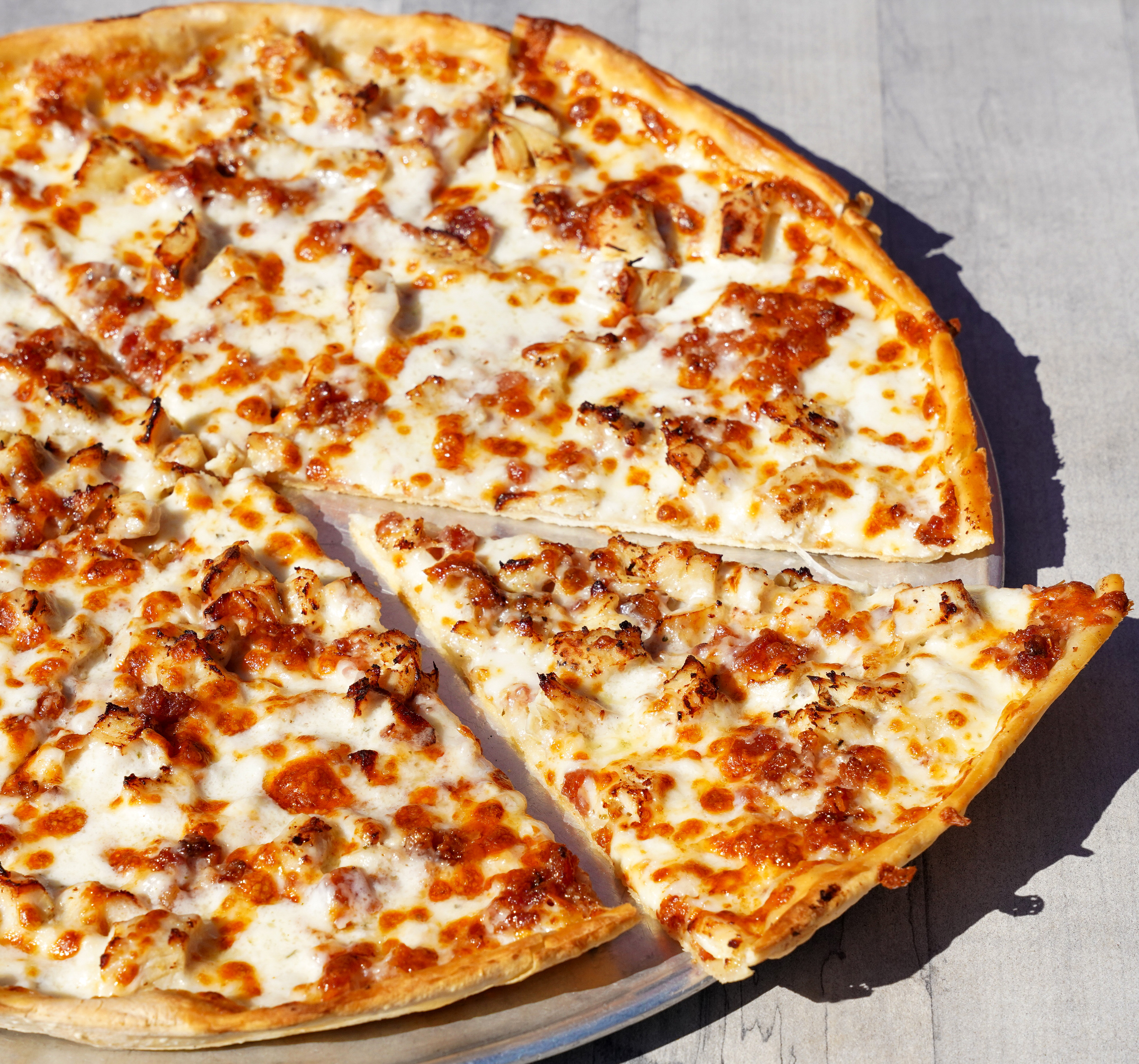 a pizza with chicken and cheese