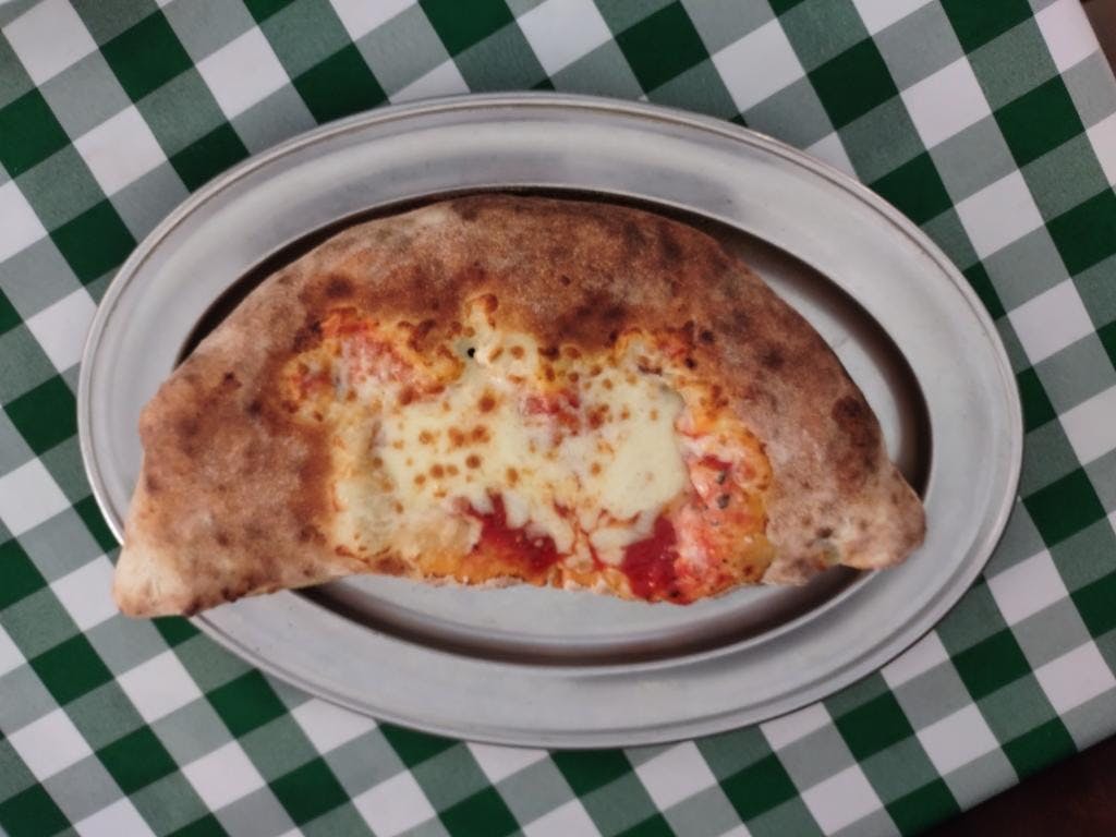 a pizza sitting on top of a plate of food