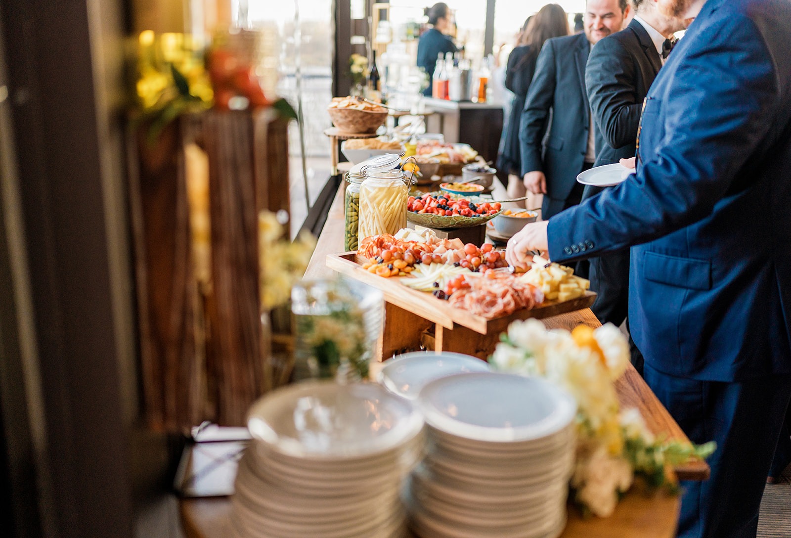 a guest helps themselves to food at a district winery event