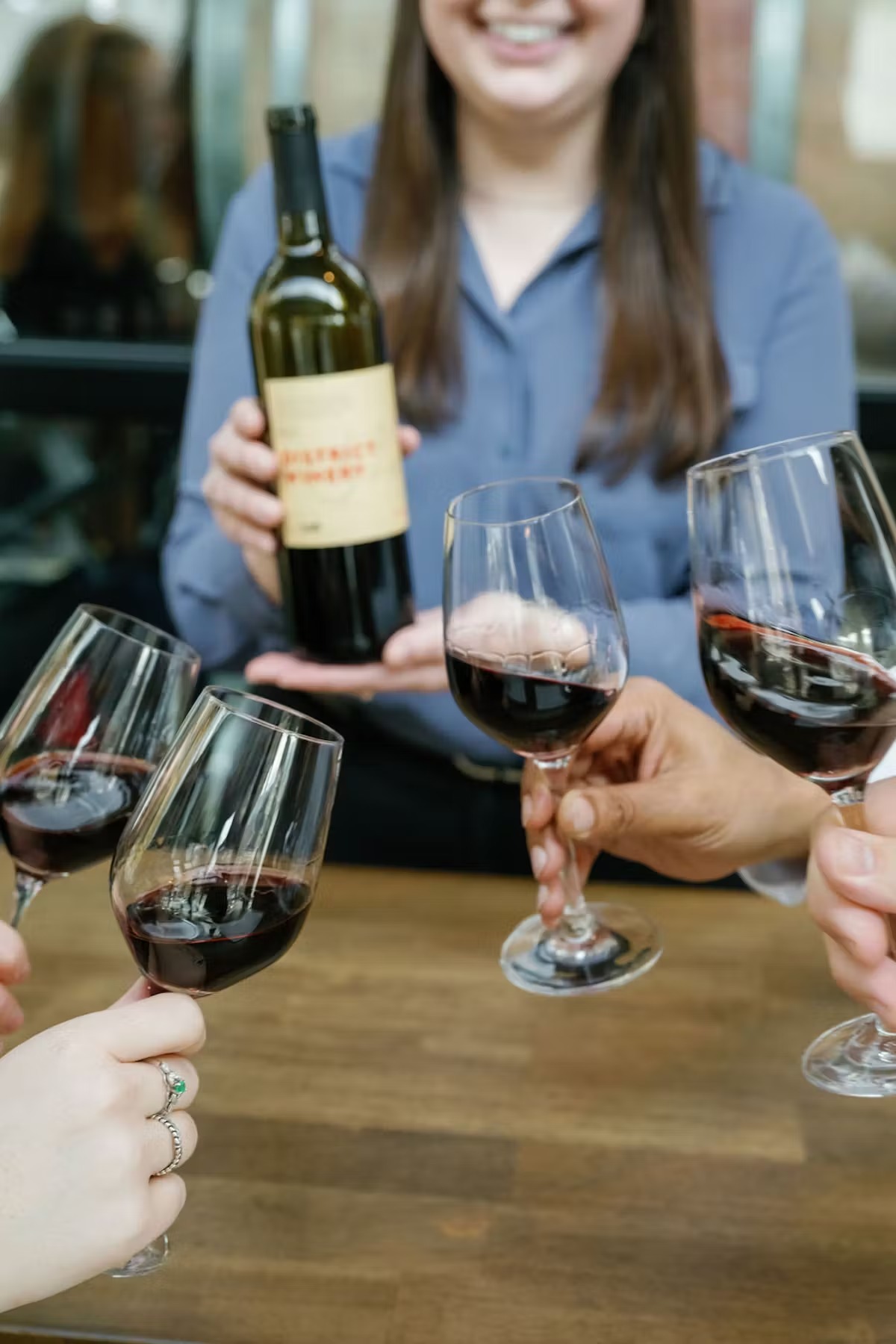 a woman holding a glass of wine