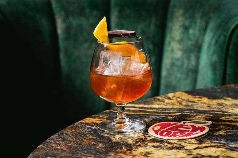 a glass of wine sitting on top of a table