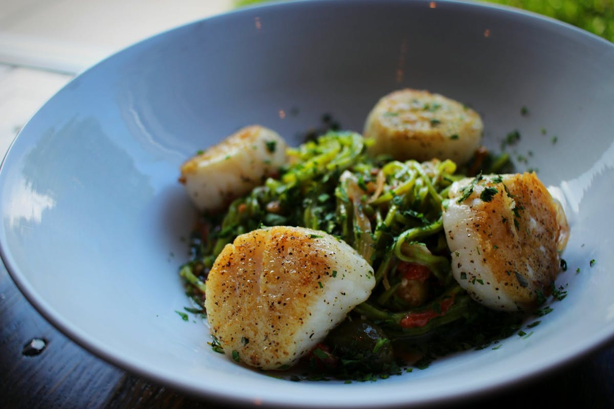 a bowl with vegetables and fish