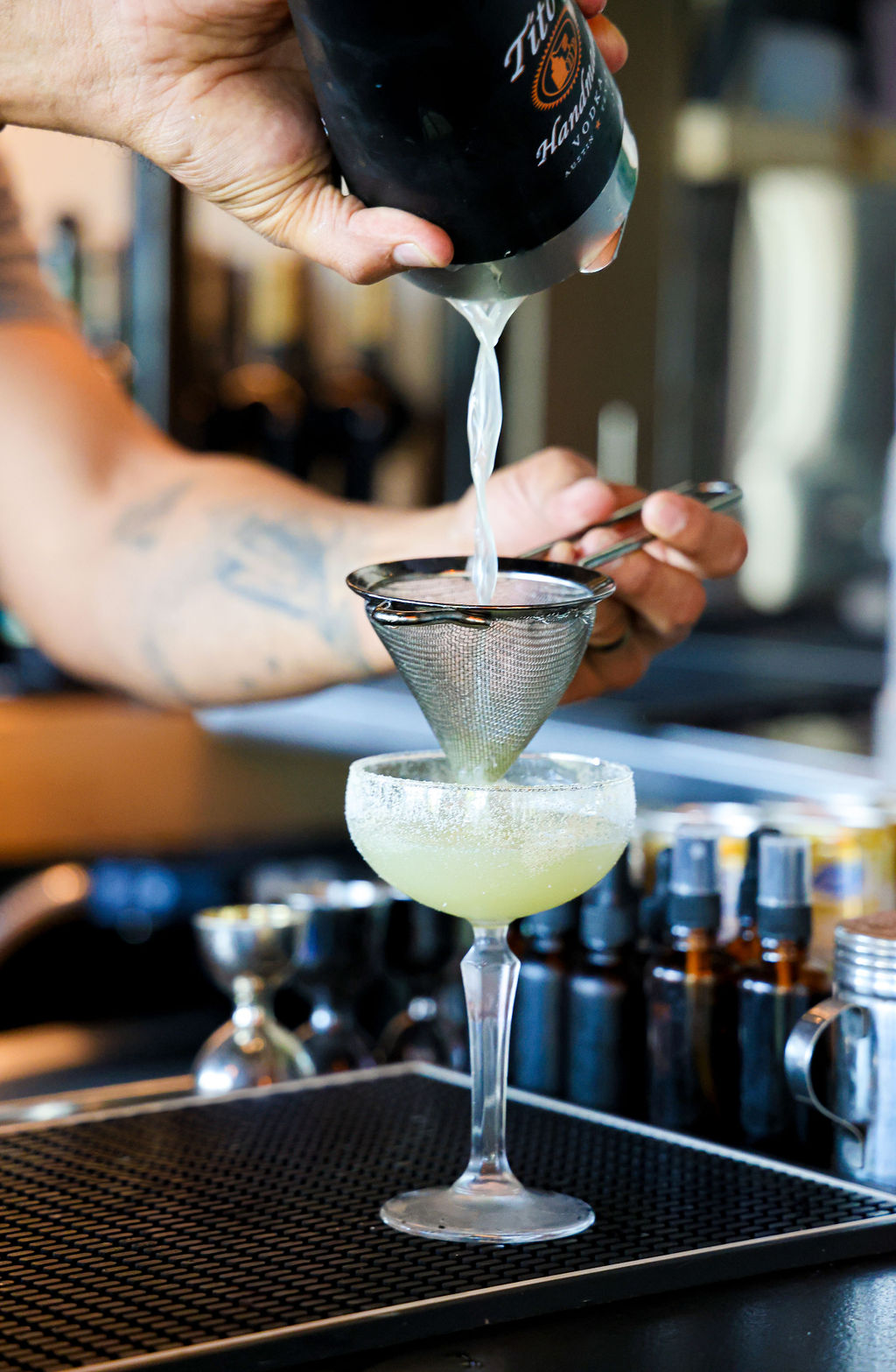 a hand holding a glass of wine