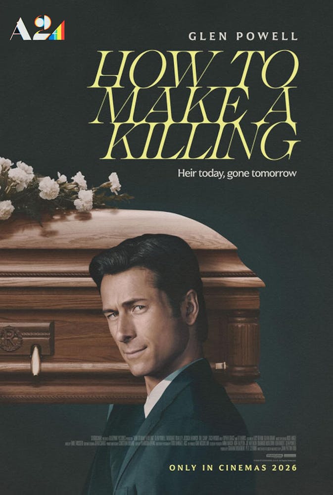 Glen Powell holding a book