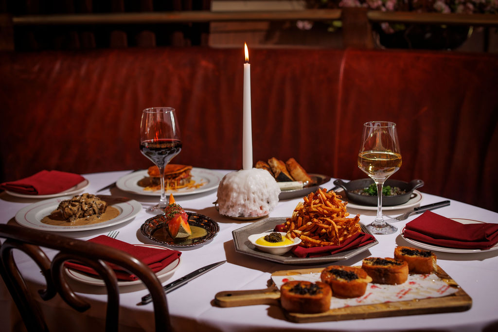 a table with food and wine glasses