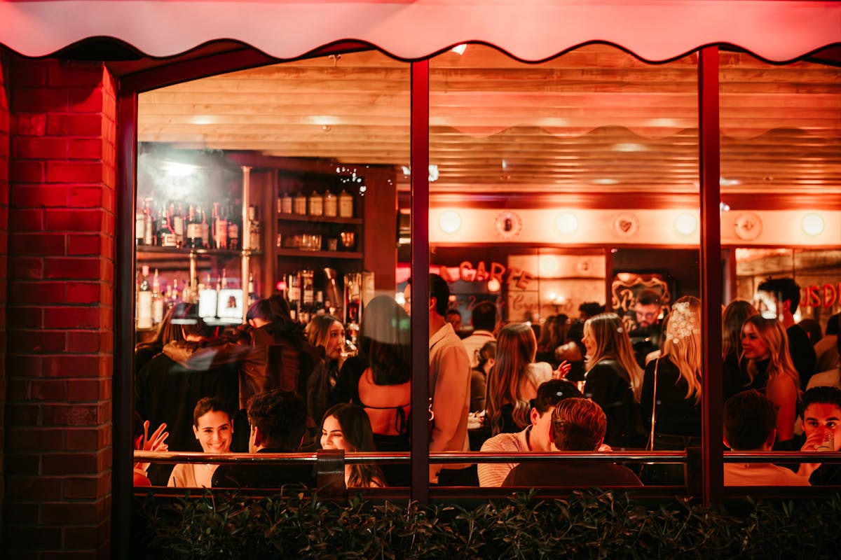 a group of people standing in front of a restaurant