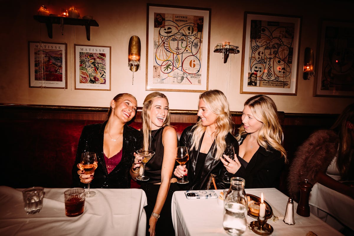 a group of people sitting at a table posing for the camera