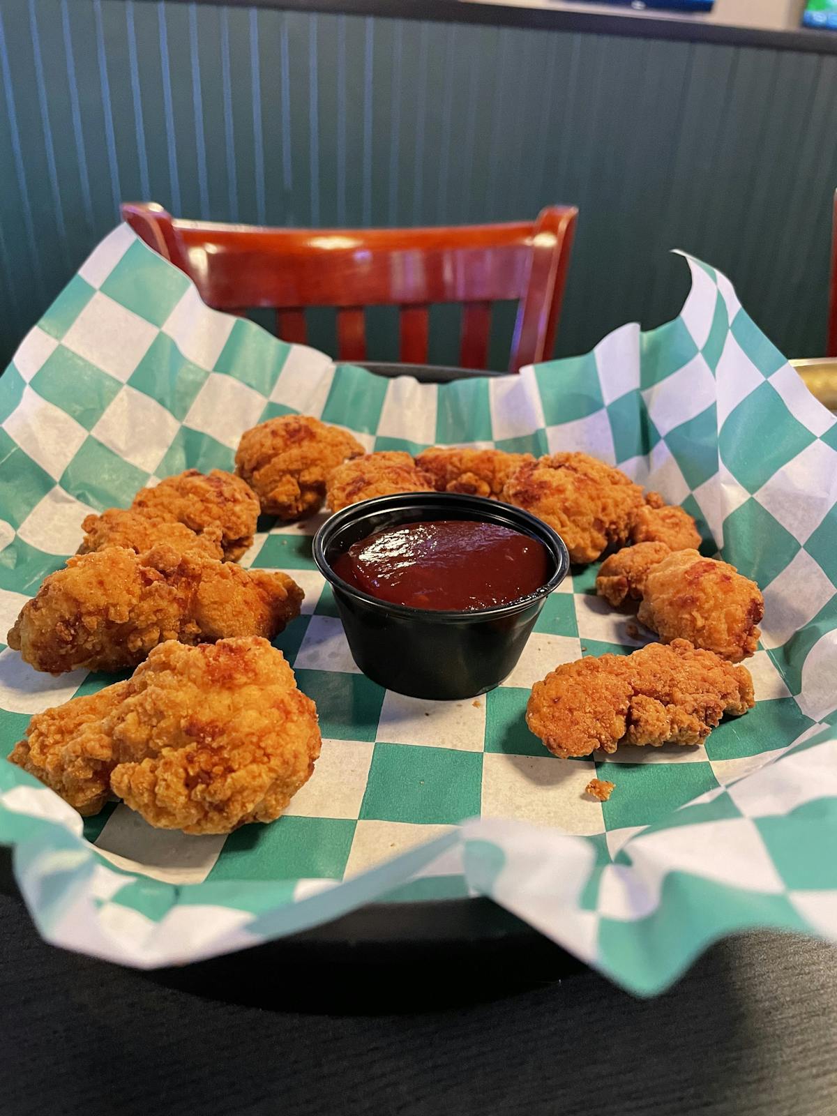 chicken wings in a basket with dipping sauce