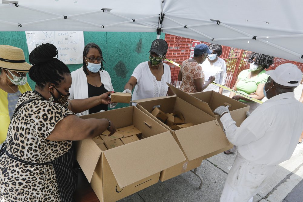 a group of people standing in front of a box