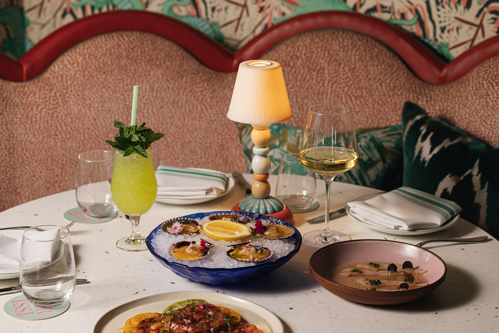 a table with plates of food and drinks