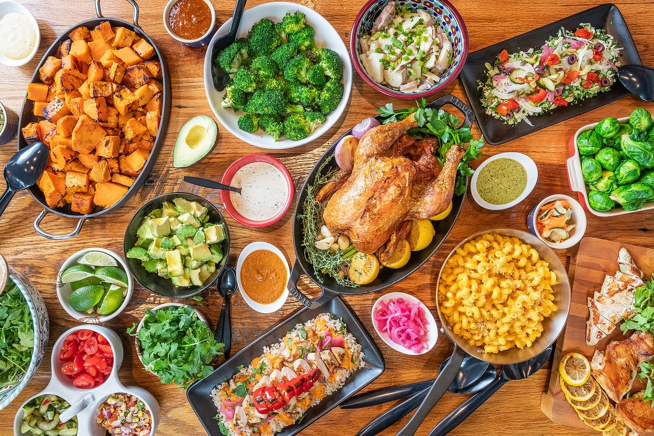 a bunch of food sitting on top of a wooden table