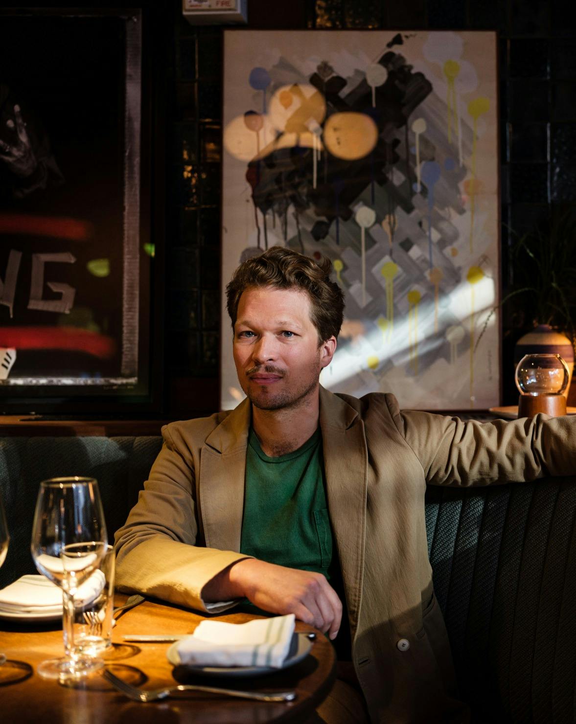 a person sitting at a table with wine glasses