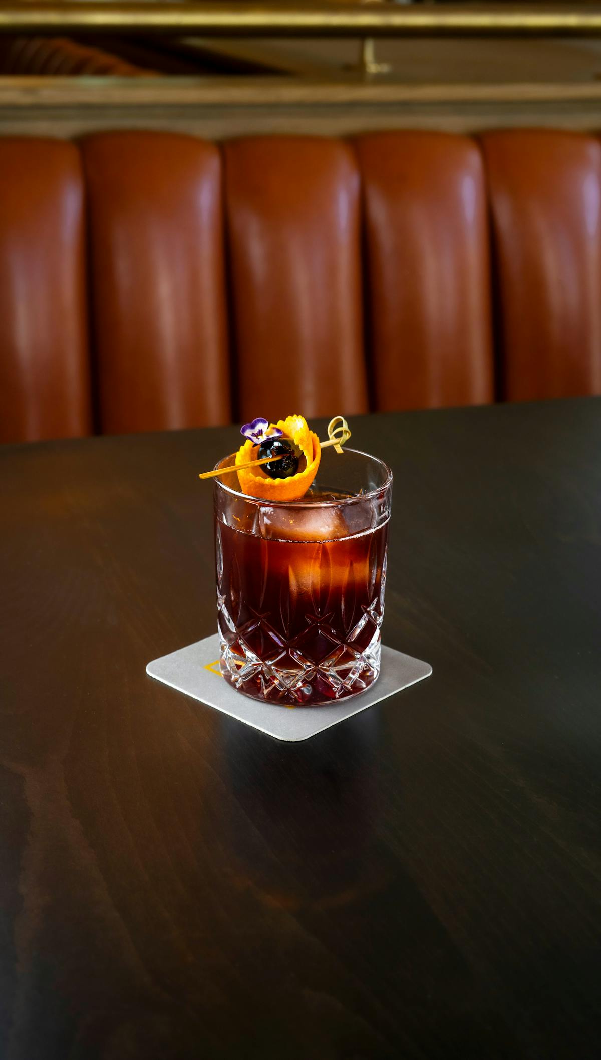 a glass of wine sitting on top of a table