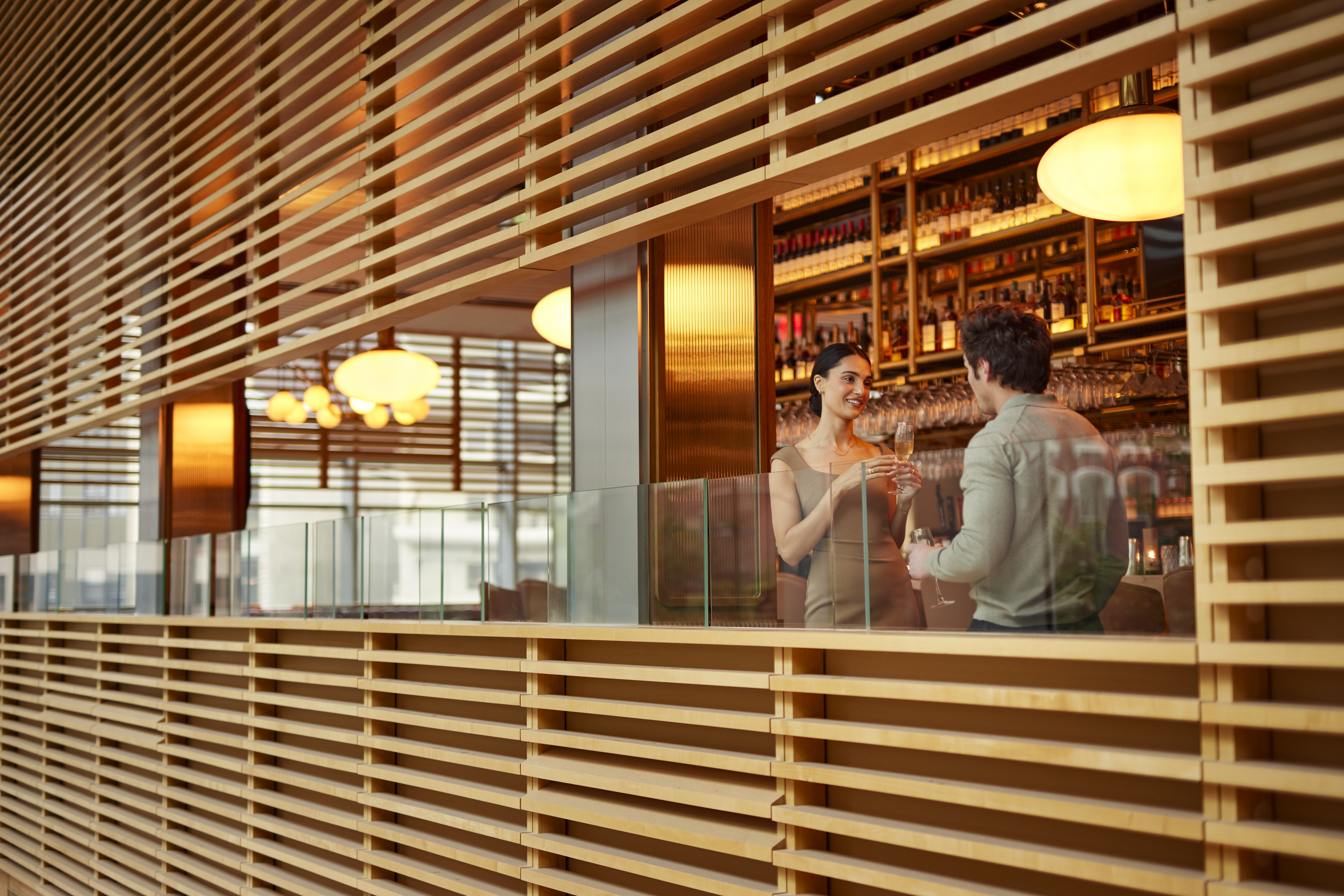 a man and woman standing in a bar