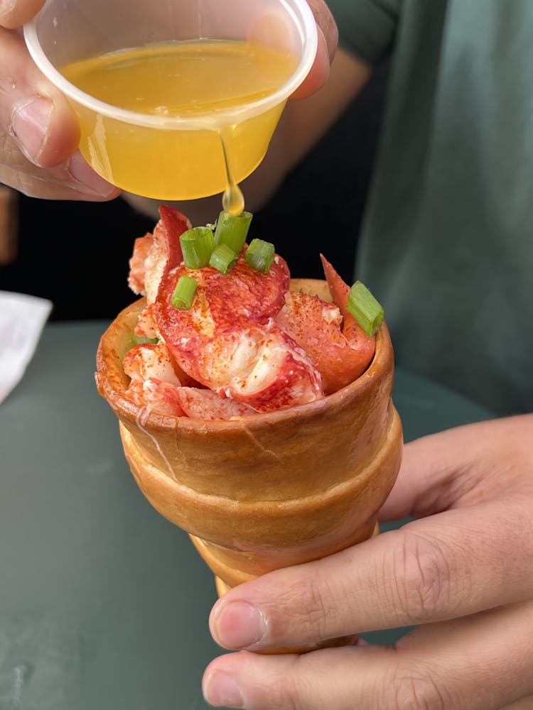 a person holding a glass of orange juice