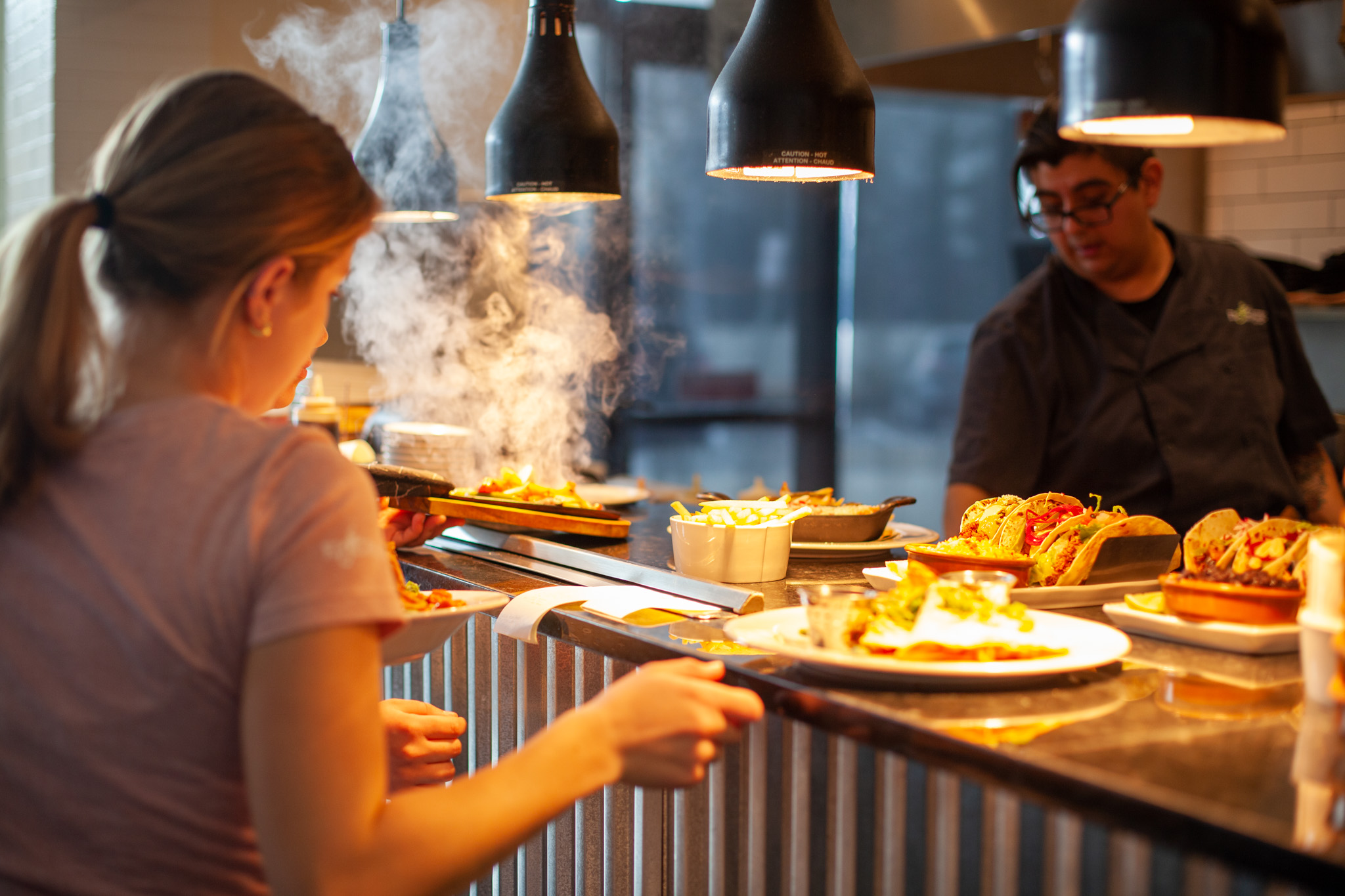 a woman preparing food in a kitchen