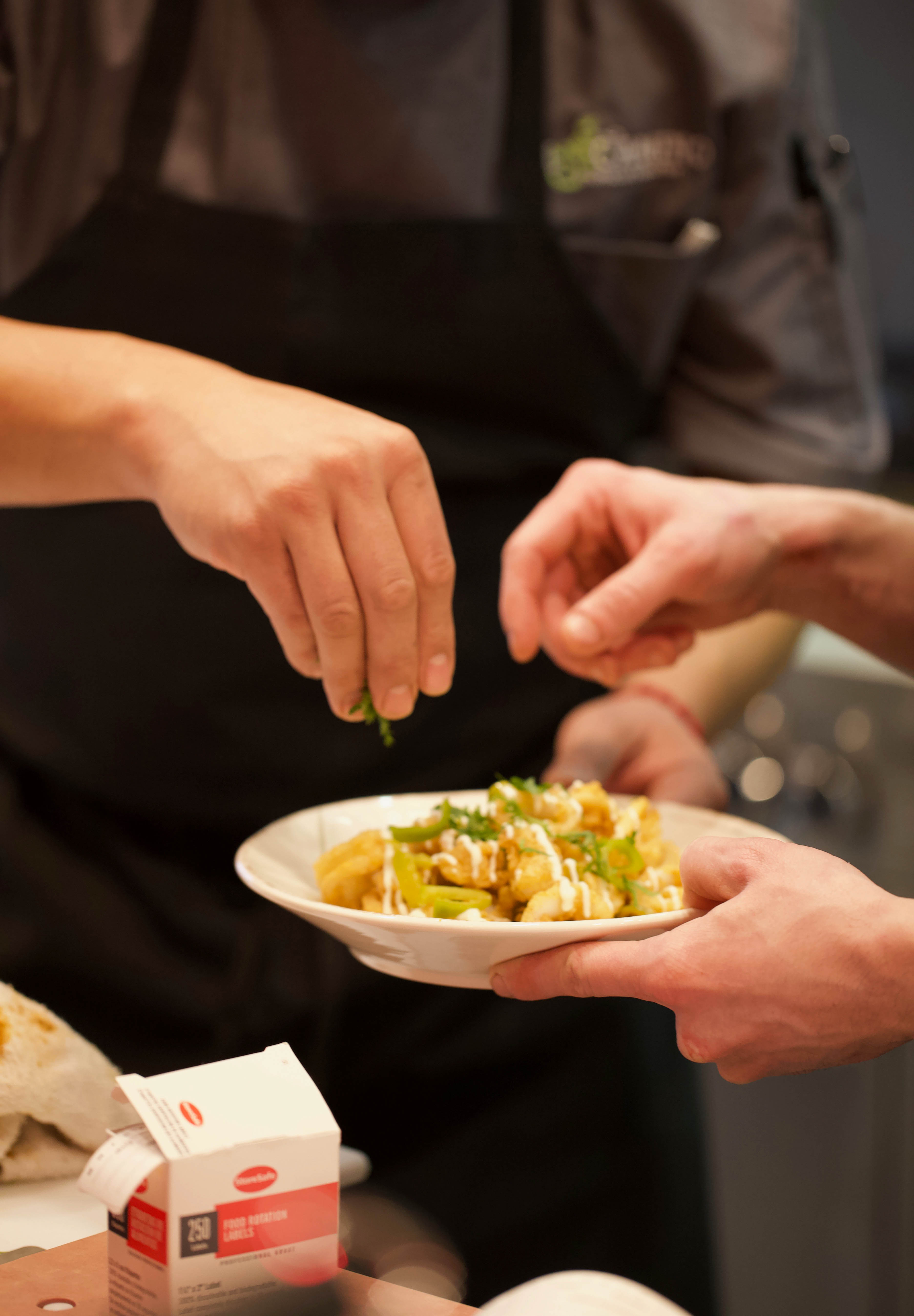a person holding a plate of food