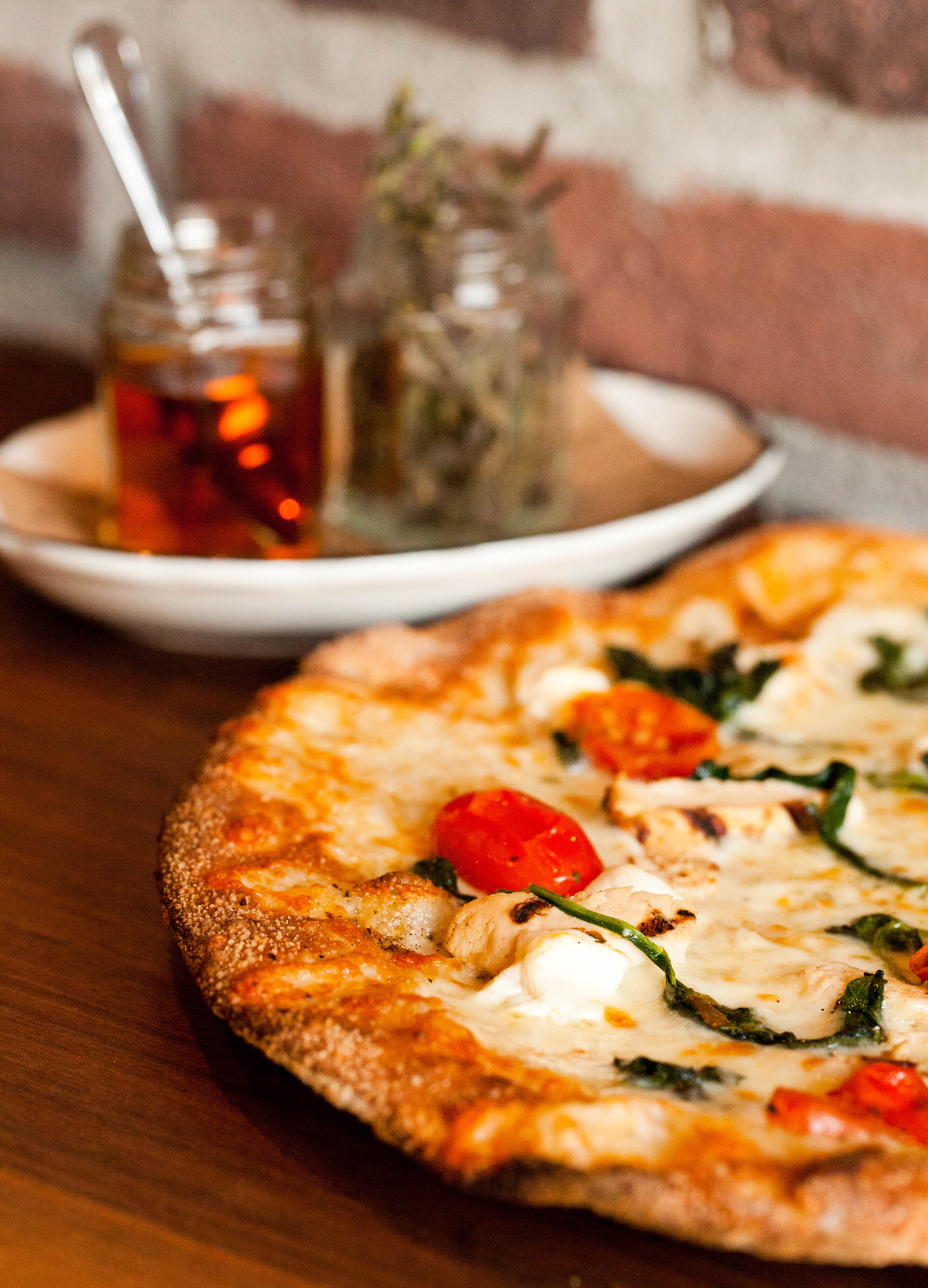 a pizza sitting on top of a wooden table